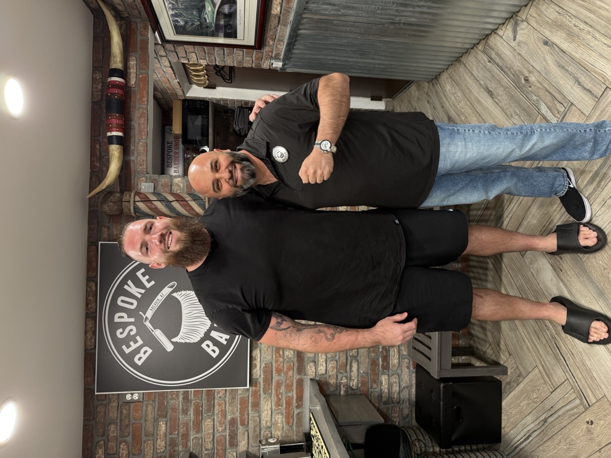 Boris posing with a notable client at Bespoke Barber