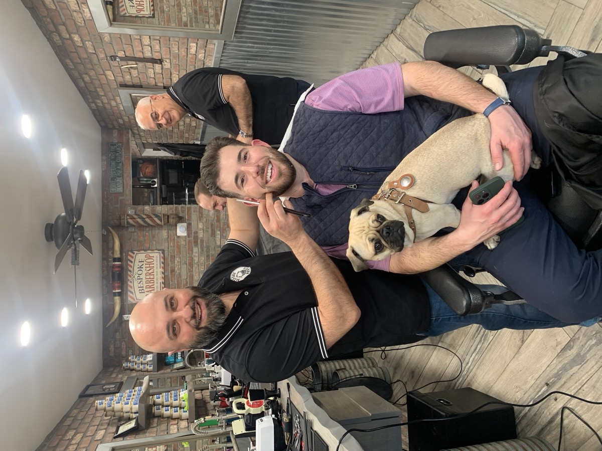 Client with his pug dog in the Bespoke Barber chair — everyone is welcome