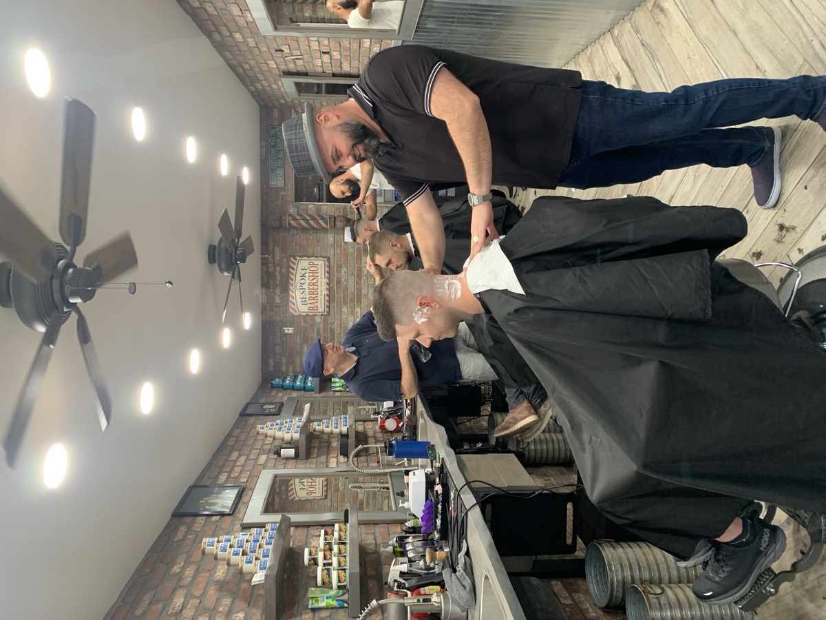 Busy day at Bespoke Barber — multiple barbers cutting hair simultaneously